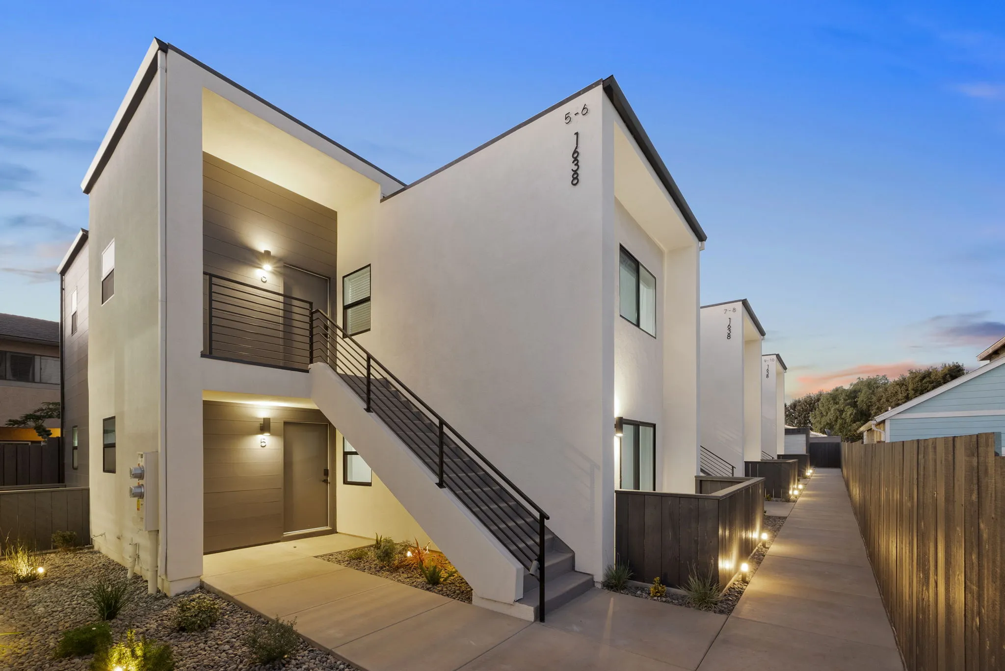Modern multi-family units at dusk, San Diego density-bonus community