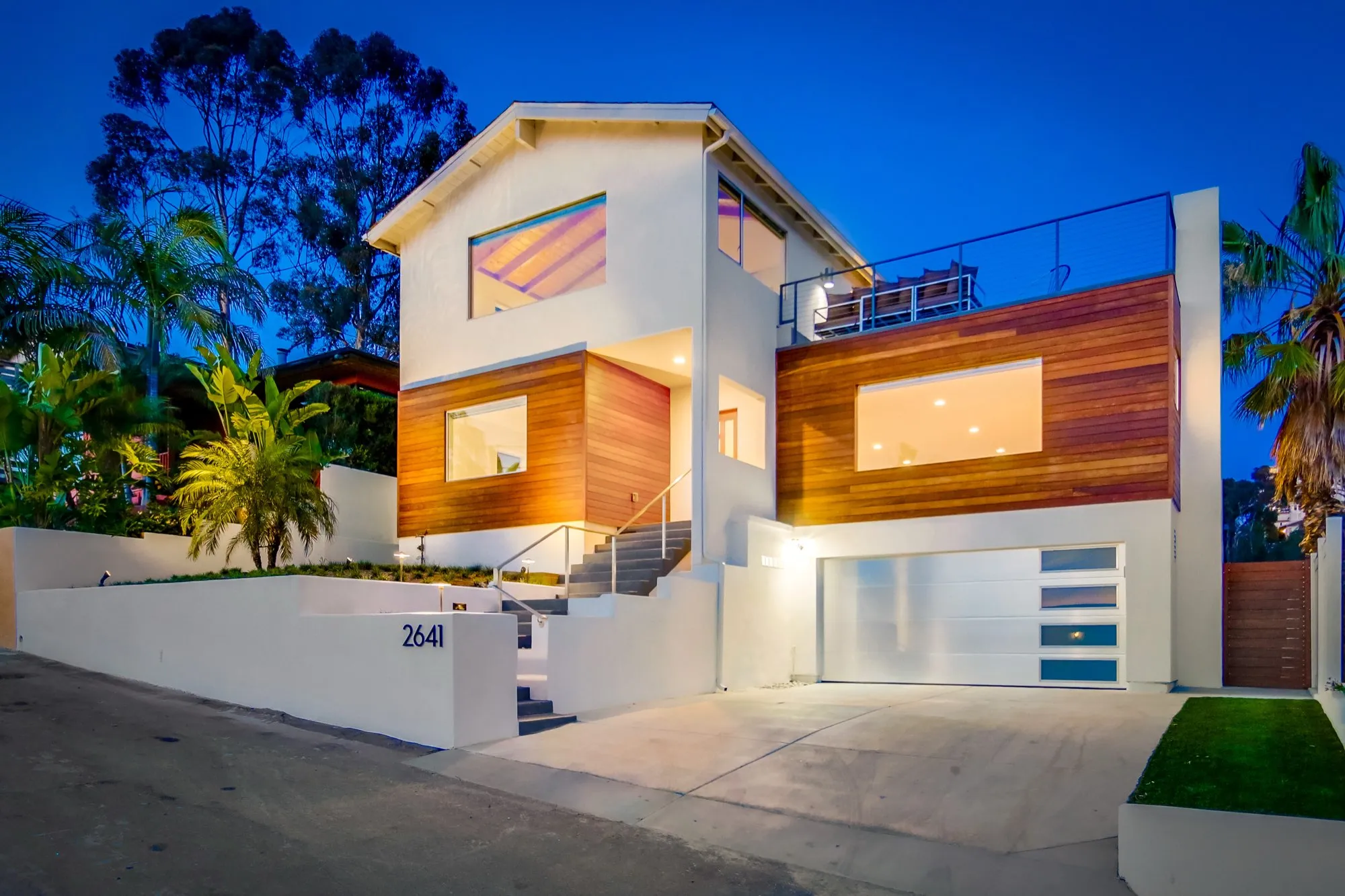 Modern two-story single-family rental home at twilight with rooftop deck, professionally managed in San Diego